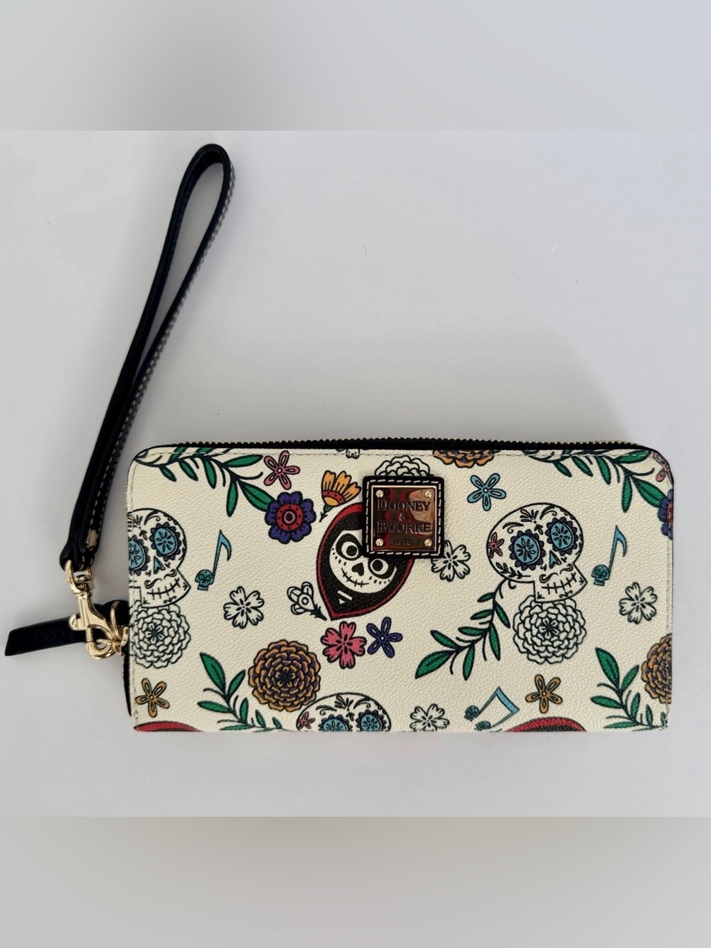 Dooney & Bourke Disney Coco- Cream Floral Sugar Skull Wristlet with Black Strap